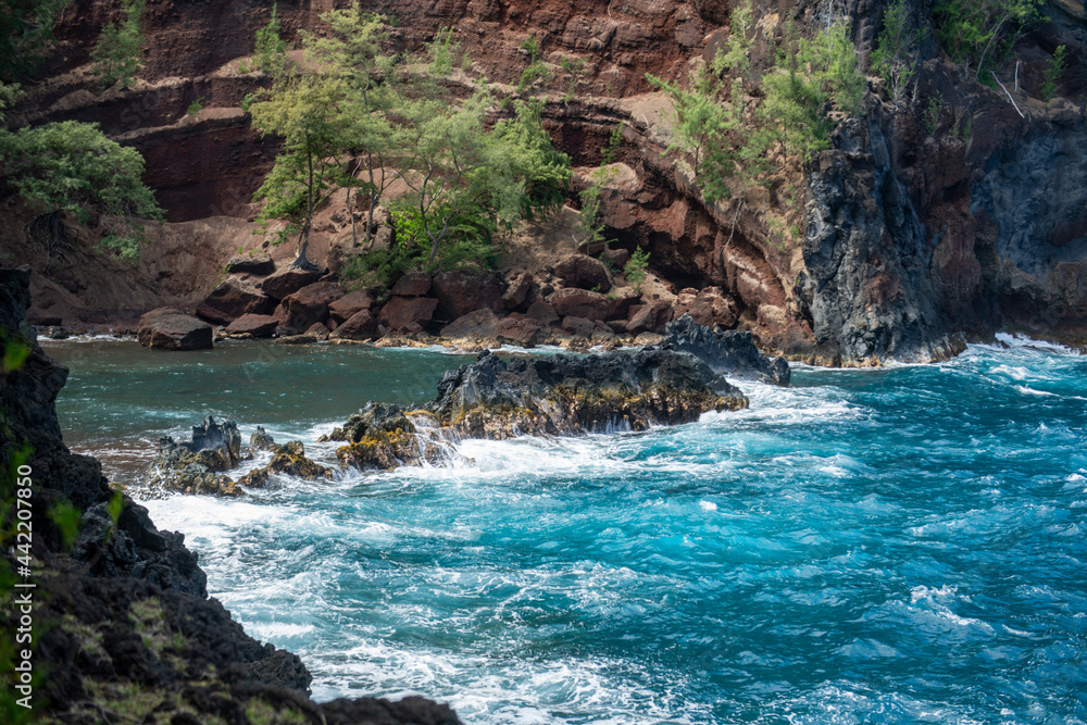 Waves on a rocky beach. Tropical paradise deep turquoise rocky seascape.