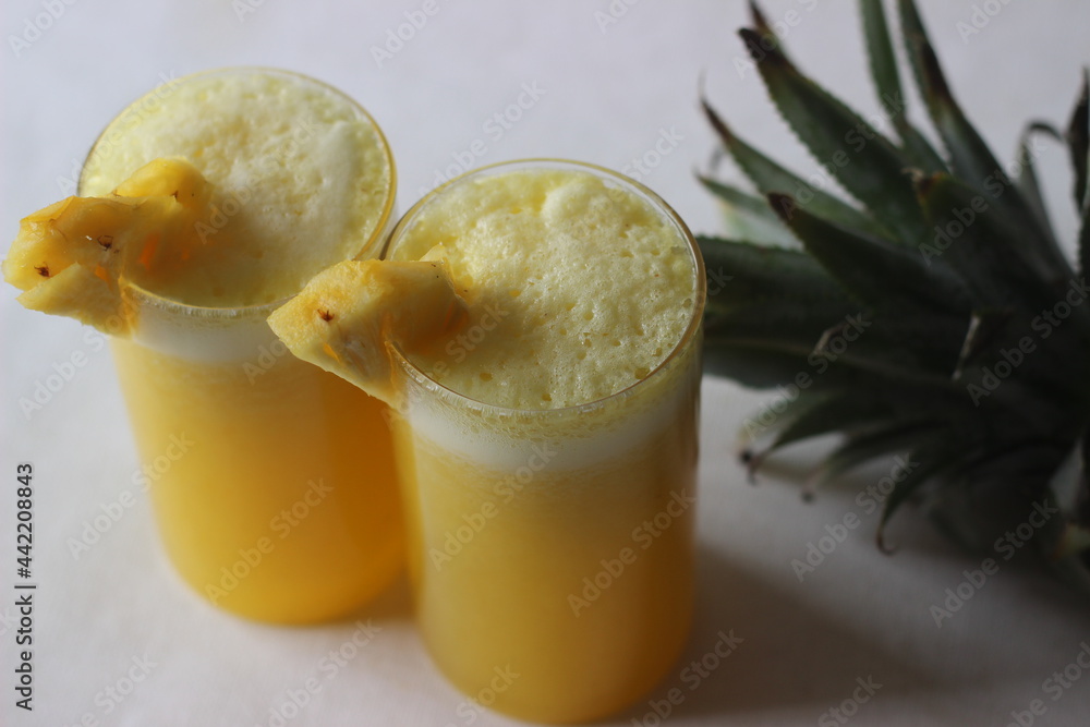 Chilled pineapple juice to beat the summer heat. Home made juice served in long glass decorated with a pineapple wedge Chilled pineapple juice to beat the summer heat. Home made juice served in long glass decorated with a pineapple wedge