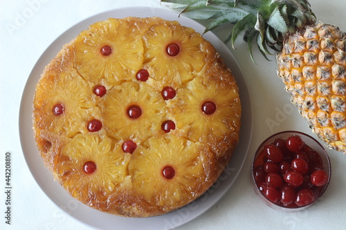 Caramelised pineapple upside down cake. Home baked pineapple cake with pineapple slices are on the top. photo