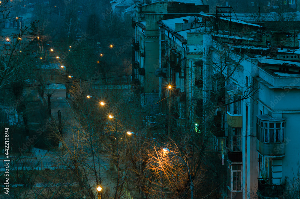 top view of old city street at twilight with street lights on
