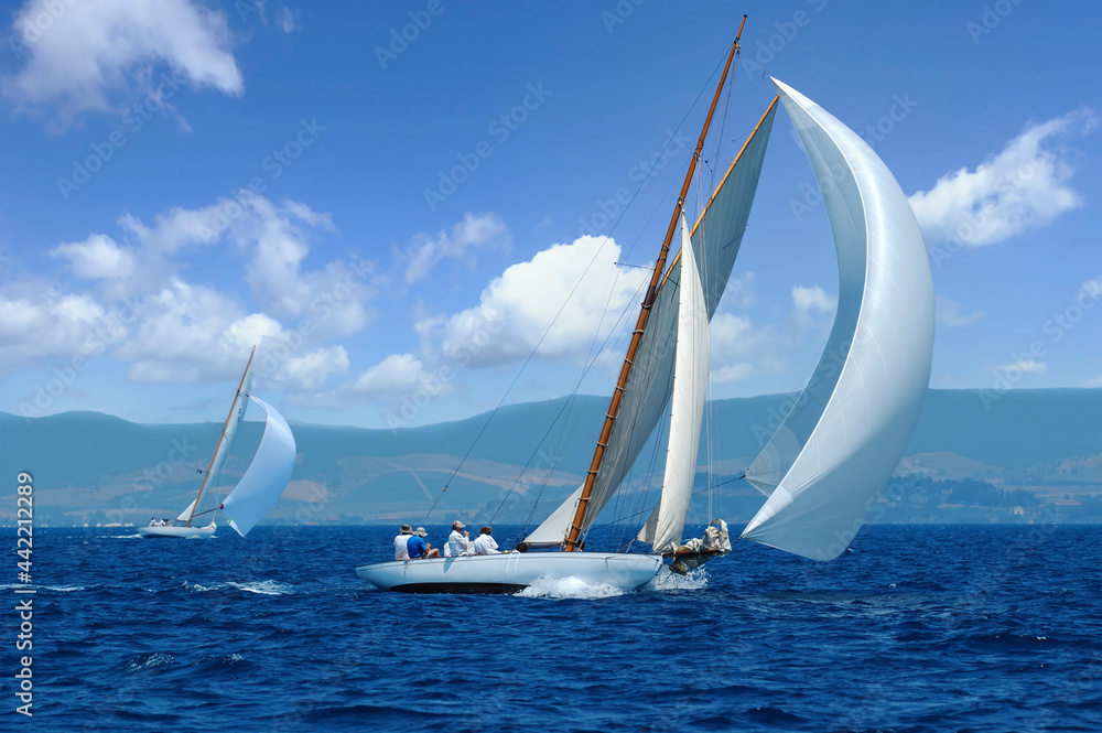 Obraz premium Vintage sailboat with white spinnaker sailing downwind 