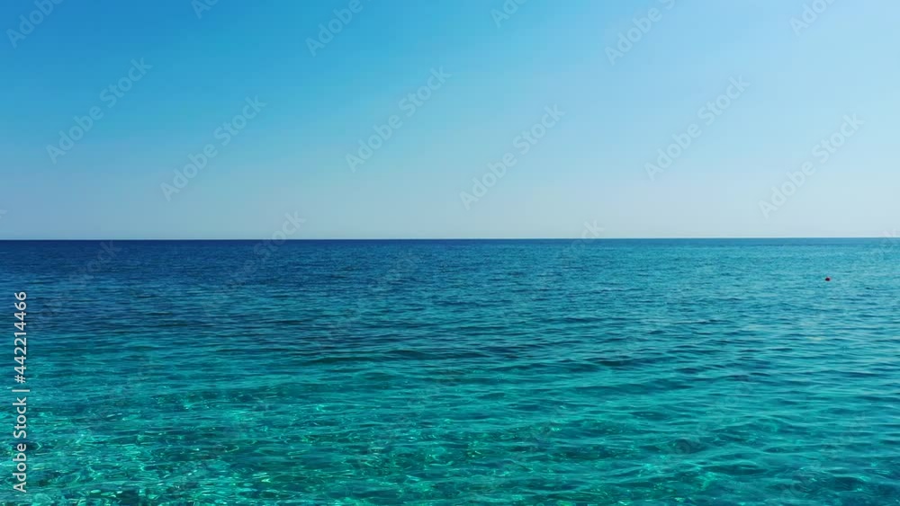 Drone flying low over the sandy beach in Horefto, Greece. It flies over the sea, and then rises up in the air. It is a sunny summer day. Drone aerial 4K stock footage Drone flying low over the sandy beach in Horefto, Greece. It flies over the sea, and then rises up in the air. It is a sunny summer day. Drone aerial 4K stock footage