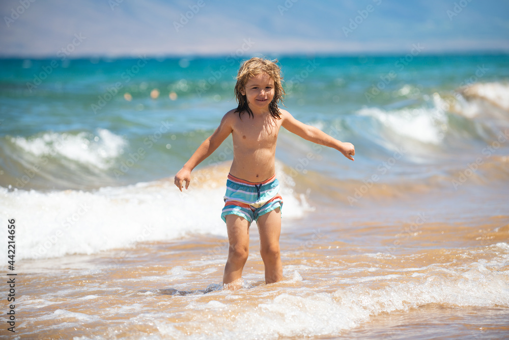 Child boy on the coast. Little kid playing in the ocean. Holidays on the sea. The child in waves. Child boy on the coast. Little kid playing in the ocean. Holidays on the sea. The child in waves.