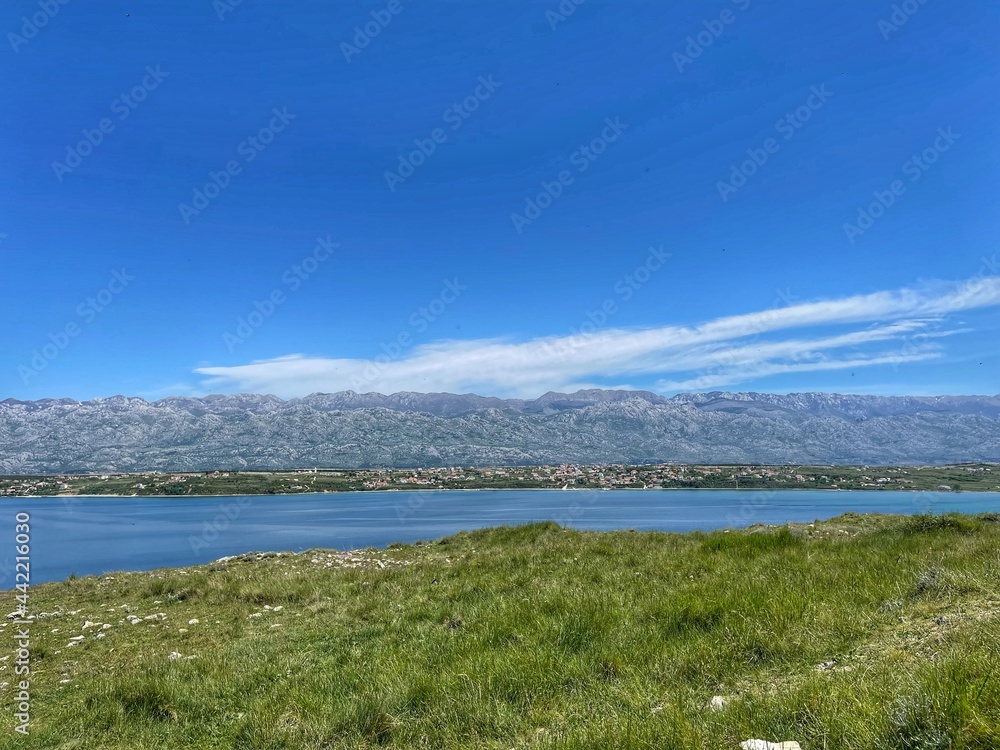 LJUBAČ, CROATIA, May 2021 - Remains of old church at the Ljubljana archaeological site and view toward Velebit mountain and Rtina LJUBAČ, CROATIA, May 2021 - Remains of old church at the Ljubljana archaeological site and view toward Velebit mountain and Rtina