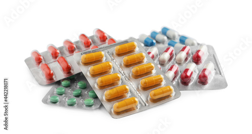 Pile of different pills in blister packs on white background photo