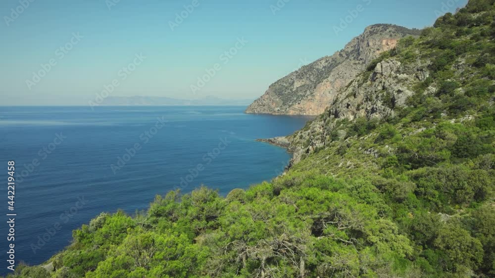 Aerial view of rocky coastline with turquoise and clear sea water surface at sunny day. Summer holiday and travel to sea Aerial view of rocky coastline with turquoise and clear sea water surface at sunny day. Summer holiday and travel to sea