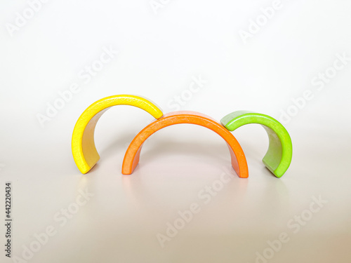 Wooden toys on a light background. The concept of child development according to the Montessori method. A colored rainbow. Previously, the development. Eco-friendly toys.