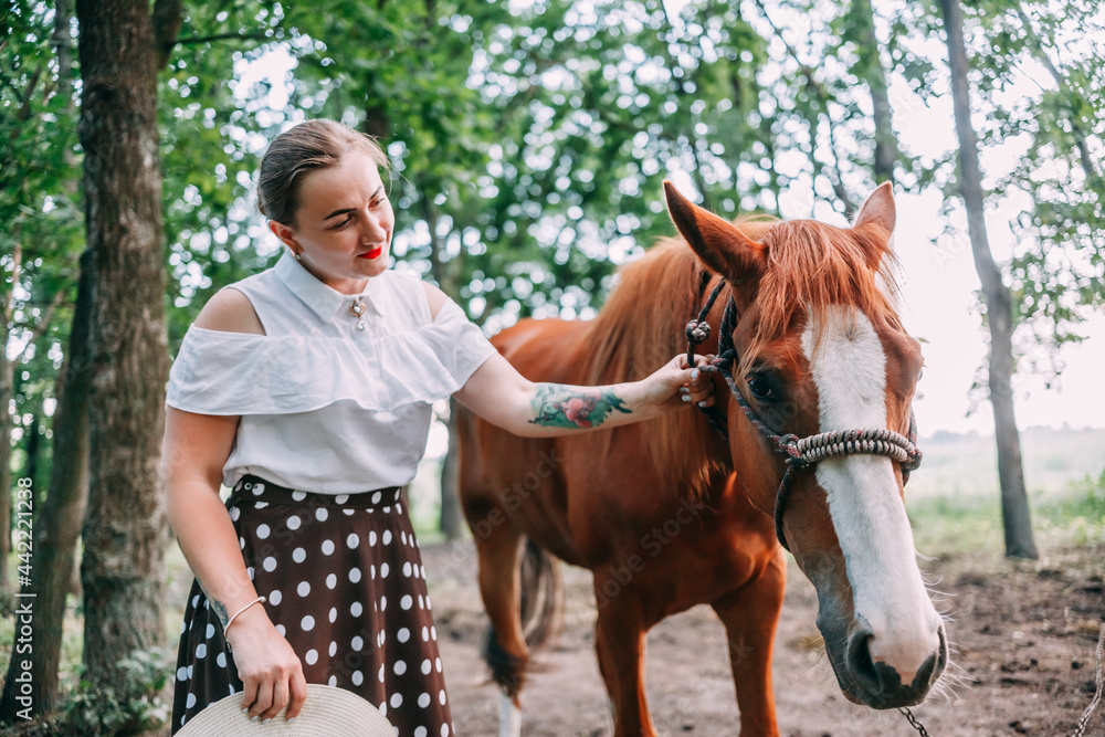 photo of a young smiling blonde, in a white blouse and skirt, with a horse, in a summer forest photo of a young smiling blonde, in a white blouse and skirt, with a horse, in a summer forest