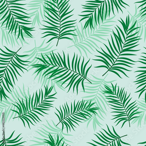 Green palm leaves seamless vector pattern © DELYRICA
