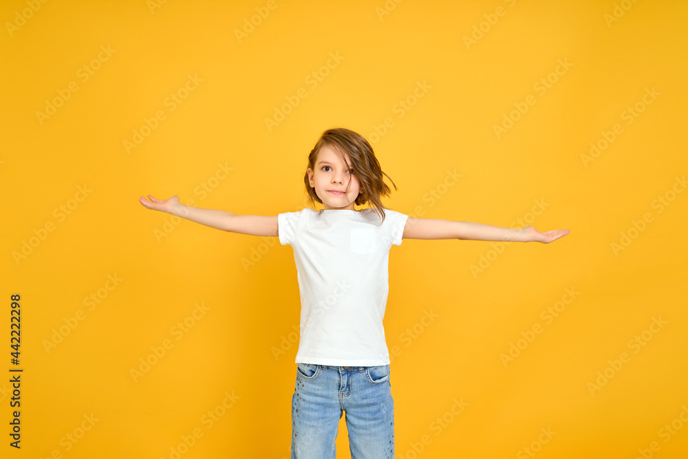 Smiling young african american woman girl in casual t-shirt posing isolated on yellow orange background studio portrait. People lifestyle concept. Mock up copy space. Spreading pointing hands aside Smiling young african american woman girl in casual t-shirt posing isolated on yellow orange background studio portrait. People lifestyle concept. Mock up copy space. Spreading pointing hands aside
