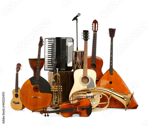 Set of different musical instruments and microphone on white background