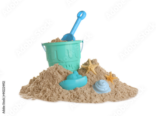 Plastic beach toys on pile of sand against white background. Outdoor play
