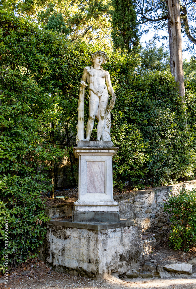 A statue depicting Bacchus or Dionysus, god of the grape-harvest, winemaking and wine, in Boboli Gardens, beside Palazzo Pitti, Florence city center, Tuscany region, Italy