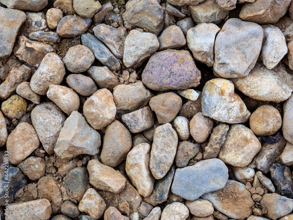 Top view of many stones of various shapes and sizes. Top view of many stones of various shapes and sizes.