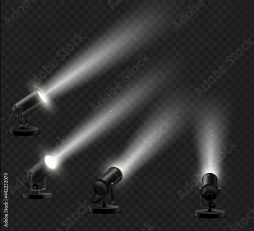 Realistic set of black floor lamps with light ray effect to decorate a showroom or showcase podium on a dark background.