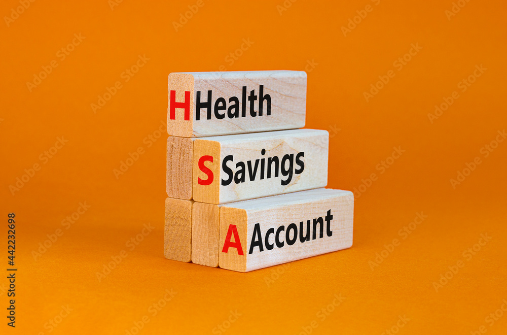 Naklejka premium HSA health savings account symbol. Concept words HSA health savings account on wooden blocks on a beautiful orange background. Business and HSA health savings account concept.