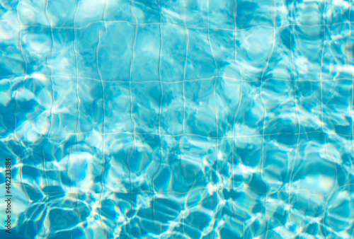 Blue ripped water with waves and rays in the swimming pool Summer vacation Background. Top view Copy space for text