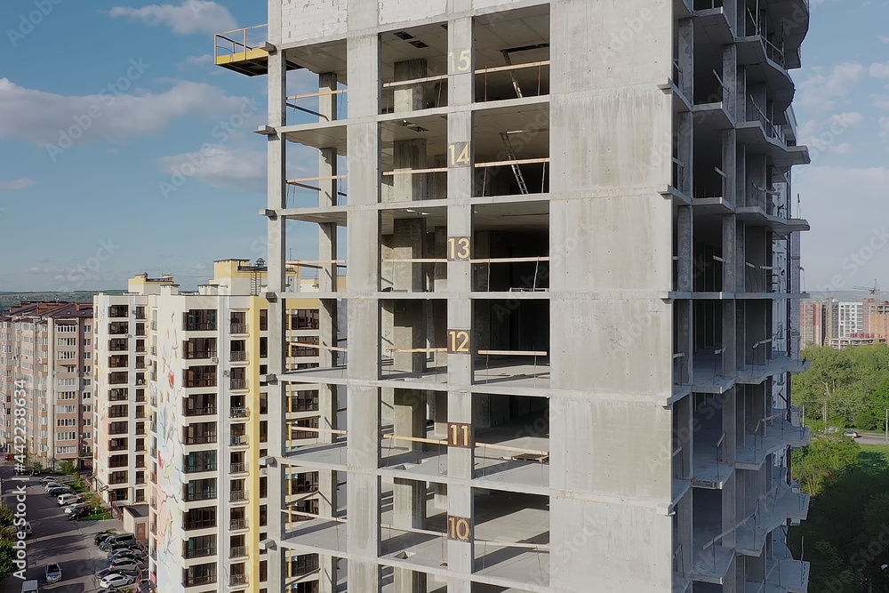 Aerial view of high residential apartment building under construction Aerial view of high residential apartment building under construction