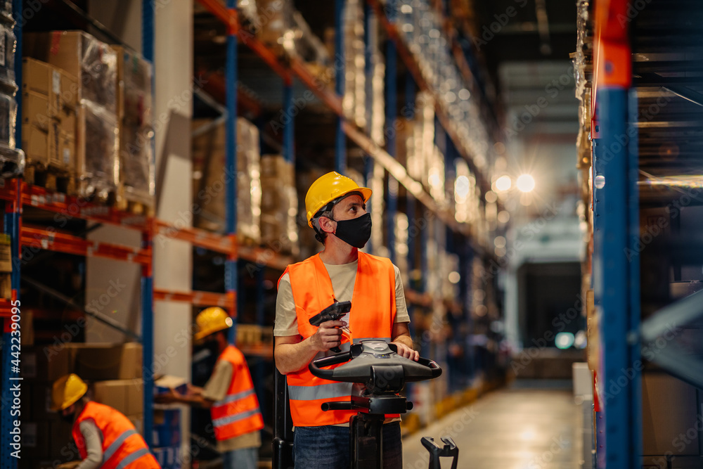 Warehouse worker holding bar-code scanner Warehouse worker holding bar-code scanner