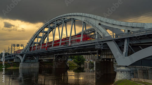 Railway bridge on the background of running clouds,