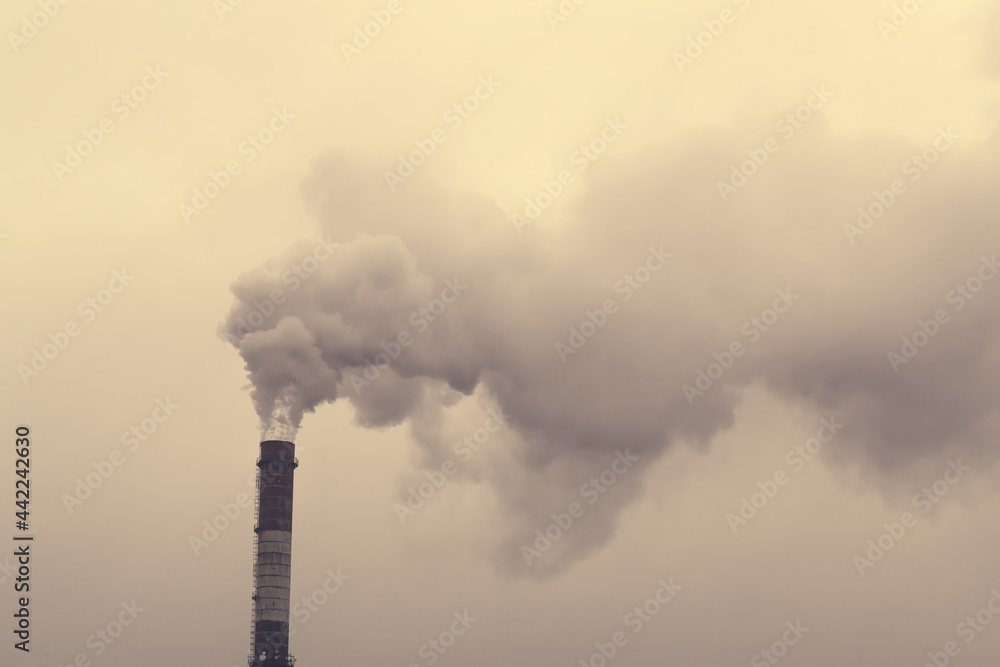 Smoking chimney of a coal power plant. Dramatic smoke. Air pollution. Release of harmful substances into the atmosphere Smoking chimney of a coal power plant. Dramatic smoke. Air pollution. Release of harmful substances into the atmosphere