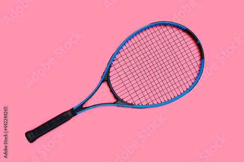 Tennis racket on pink background. © Bowonpat