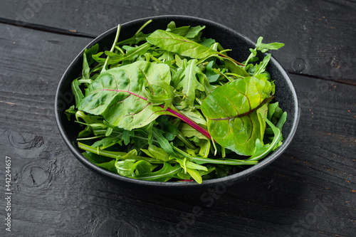 Arugula, Chard herbs mix , on black wooden table background