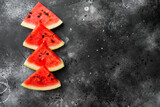 Fresh cut watermelon, on black dark stone table background, top view flat lay, with copy space for text