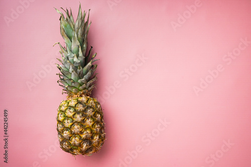 Pineapple whole, on pink textured summer background, top view flat lay, with copy space for text