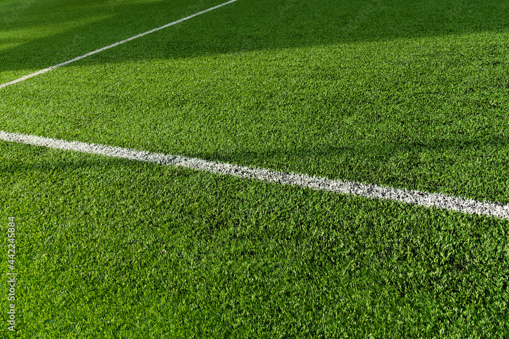 green artificial grass football or soccer field with white line background