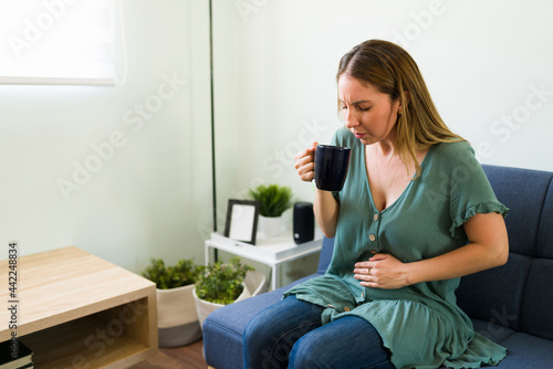 Sick woman suffering from indigestion