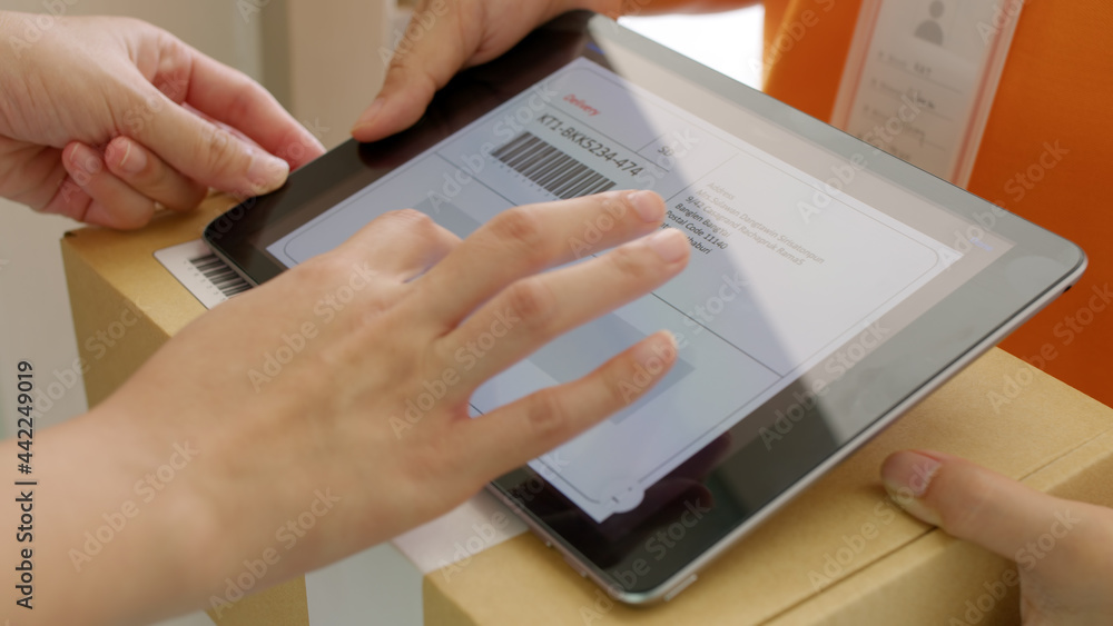 Fototapeta premium Close-up hand asia people girl send receive pickup express postal post mail from retail order online e-commerce store worker carry container and smart digital tablet device at door home city life.