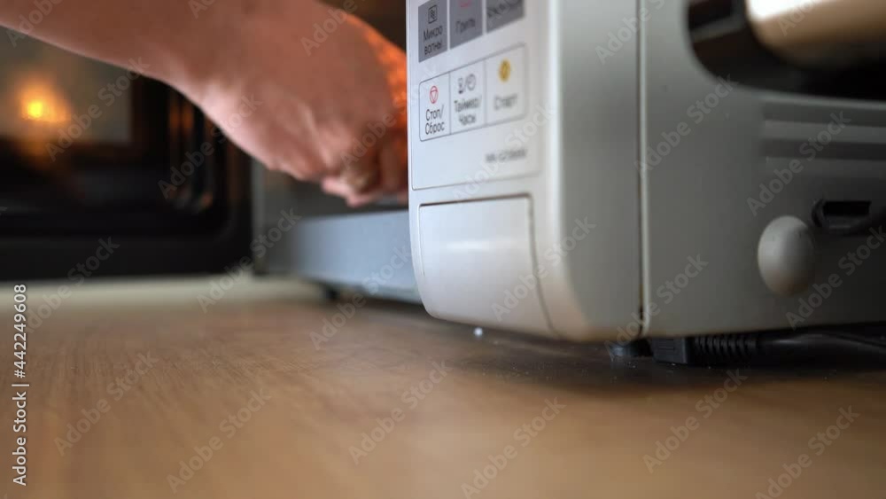 Point of view shot of a man using a microwave oven in a kitchen. 4k stock footage. Point of view shot of a man using a microwave oven in a kitchen. 4k stock footage.
