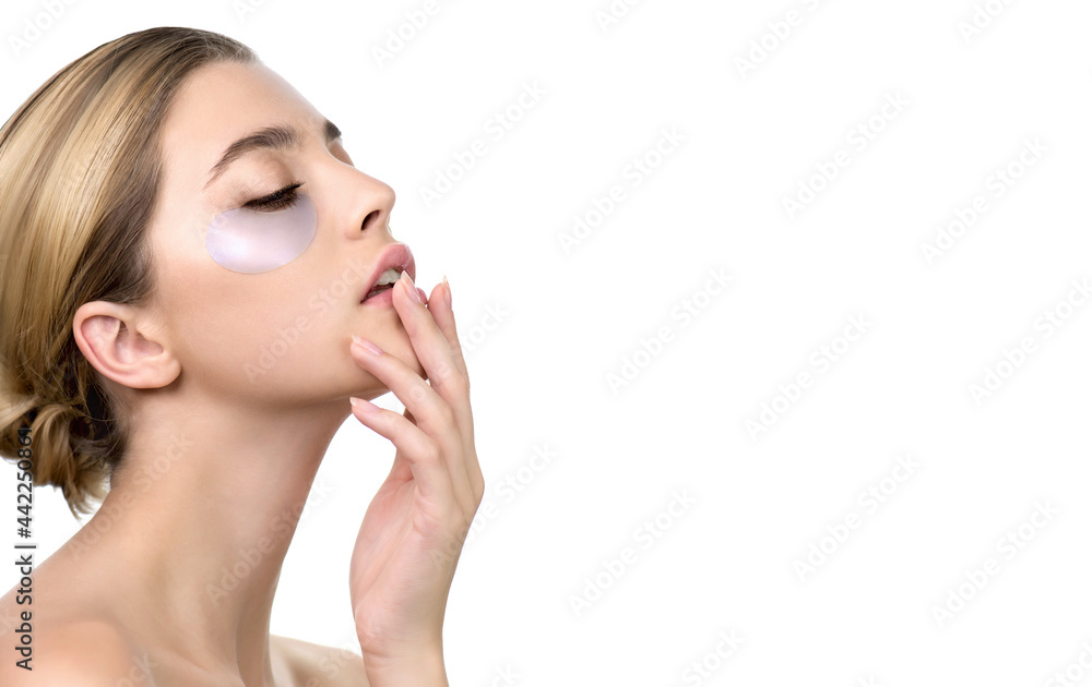 Beautiful young woman applies holographic, moisturizing eye mask, isolated on white. Portrait of beauty model with natural nude make up with eye patches. Spa, skincare and wellness Beautiful young woman applies holographic, moisturizing eye mask, isolated on white. Portrait of beauty model with natural nude make up with eye patches. Spa, skincare and wellness