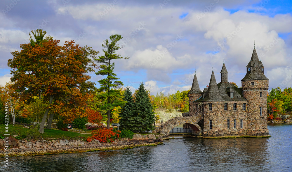 Naklejka premium Historic Boldt Castle on Heart Island. Tree, leaves, river, blue sky.