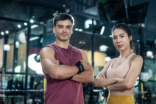 Portrait of Active athlete people standing and crossing arms in gym.