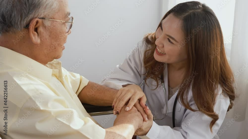 Female nurse doctor wear white uniform holding hand of patient senior or elderly old man during sit on wheelchair encourage and empathy at nursing hospital, older people healthcare support concept Female nurse doctor wear white uniform holding hand of patient senior or elderly old man during sit on wheelchair encourage and empathy at nursing hospital, older people healthcare support concept