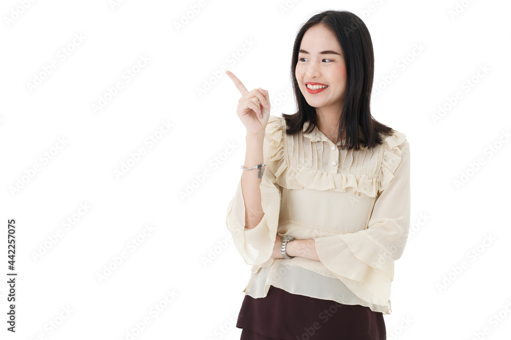 Vertical portrait shot of a cute smiling young Asian woman looking at the camera while pointing to the side of the image to presenting and showing advertising product isolated on white background Vertical portrait shot of a cute smiling young Asian woman looking at the camera while pointing to the side of the image to presenting and showing advertising product isolated on white background