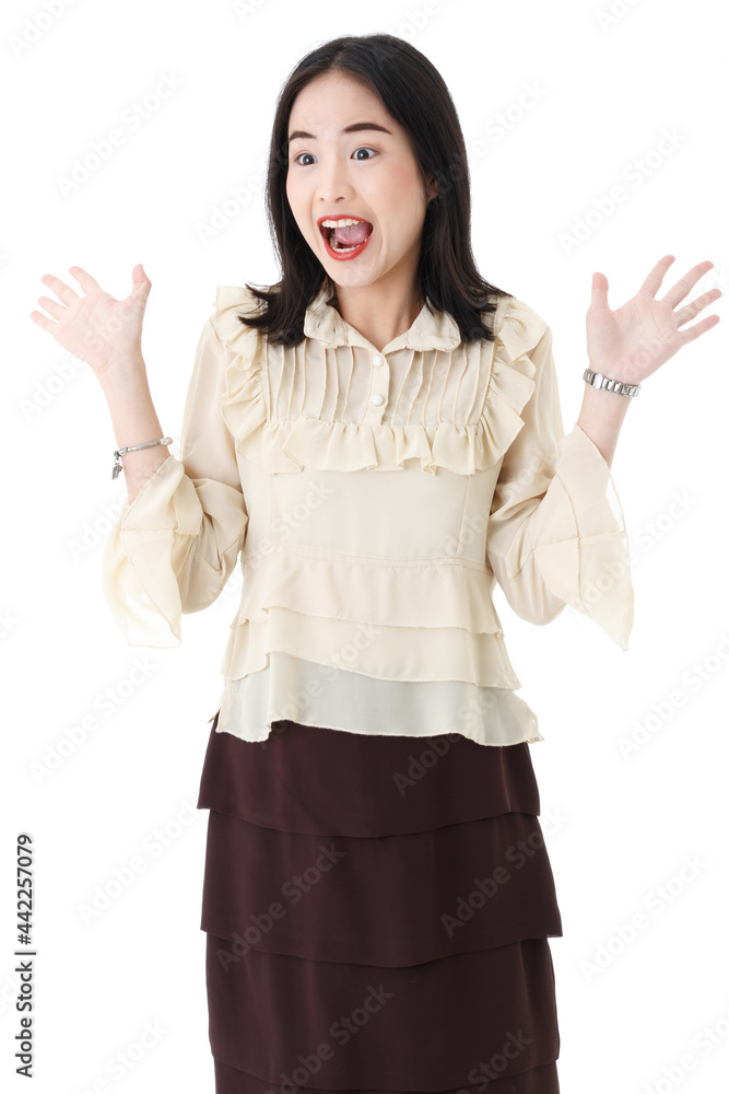 Vertical portrait shot of an optimistic young adult Asian woman with a stylish straight black hairstyle standing and looking at the side of the image with raising hand up. Excited female shout loudly Vertical portrait shot of an optimistic young adult Asian woman with a stylish straight black hairstyle standing and looking at the side of the image with raising hand up. Excited female shout loudly