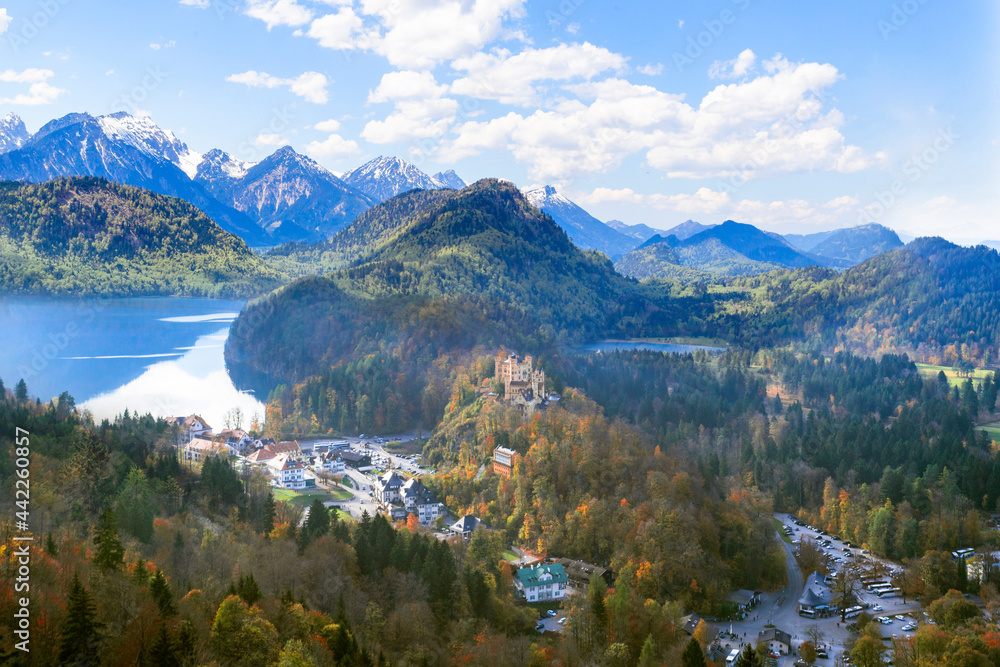 Landscape with Hohenschwangau Castle, Bavaria, Germany. Beautiful panorama of mountain lakes. Scenery of Alpine nature in autumn. Aerial scenic view of village in Alps.