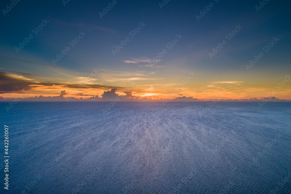 Sunset of the the Ocean with orange and blue and movement on the ocean surface with wind Sunset of the the Ocean with orange and blue and movement on the ocean surface with wind