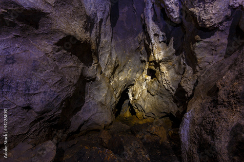 Chandolaz ridge cave in the Primorsky region. A deep cave illuminated by a flashlight.
