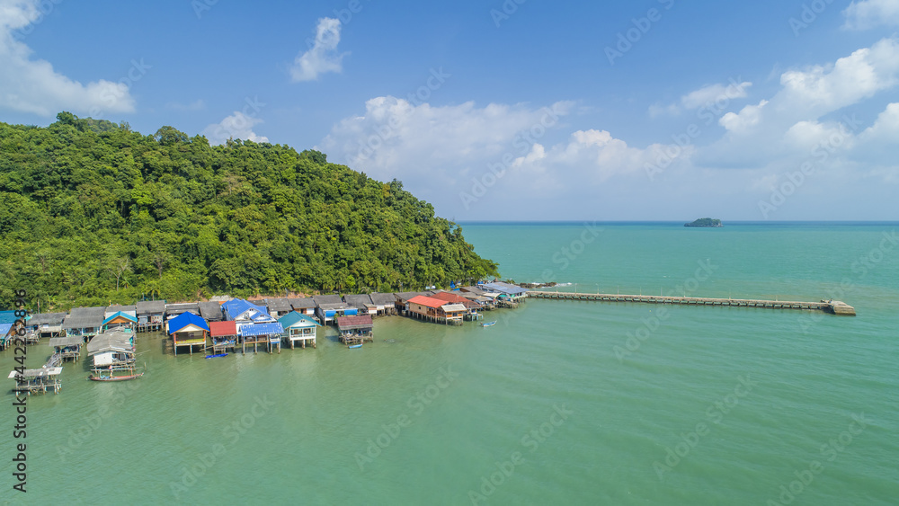 Fishing Village in Chumphon, Thailand. with clouds and mountains in the background and copy space