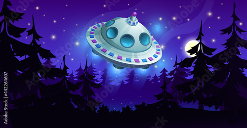 Alien flying saucer from space. Spaceship in the night sky over the forest.