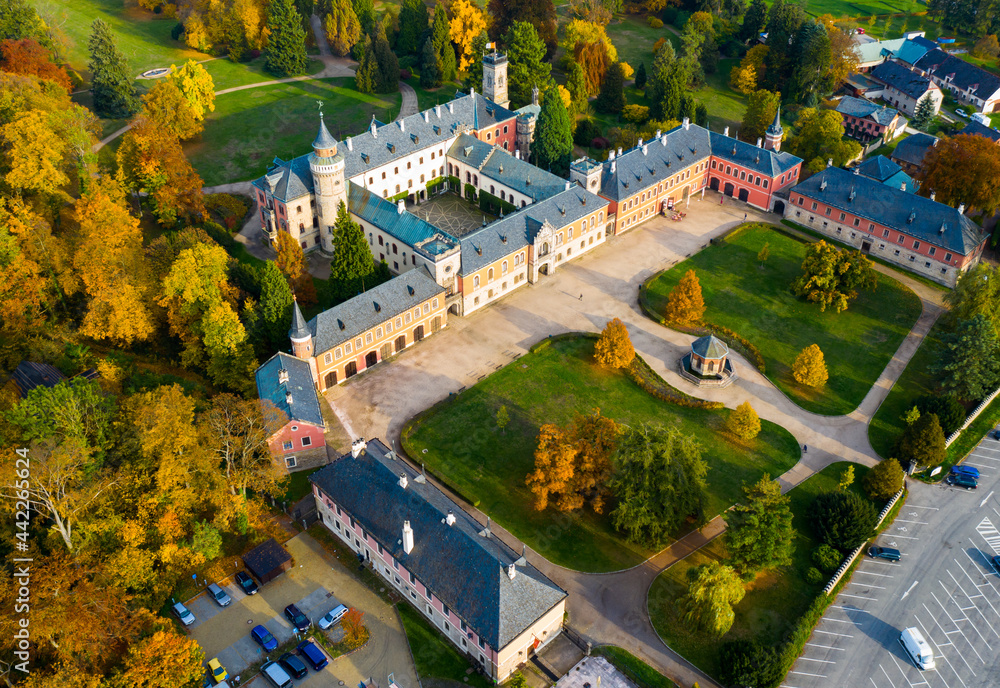 Scenic aerial view of historical neo-gothic Sychrov castle with colorful fall park, Czech Republic