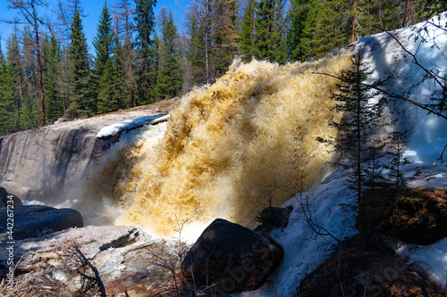 Gorgeous May waterfall in the mountain taiga