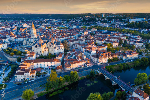 Scenic summer landscape of Perigueux with medieval Catholic Cathedral on bank of Isle river at daybreak  France..