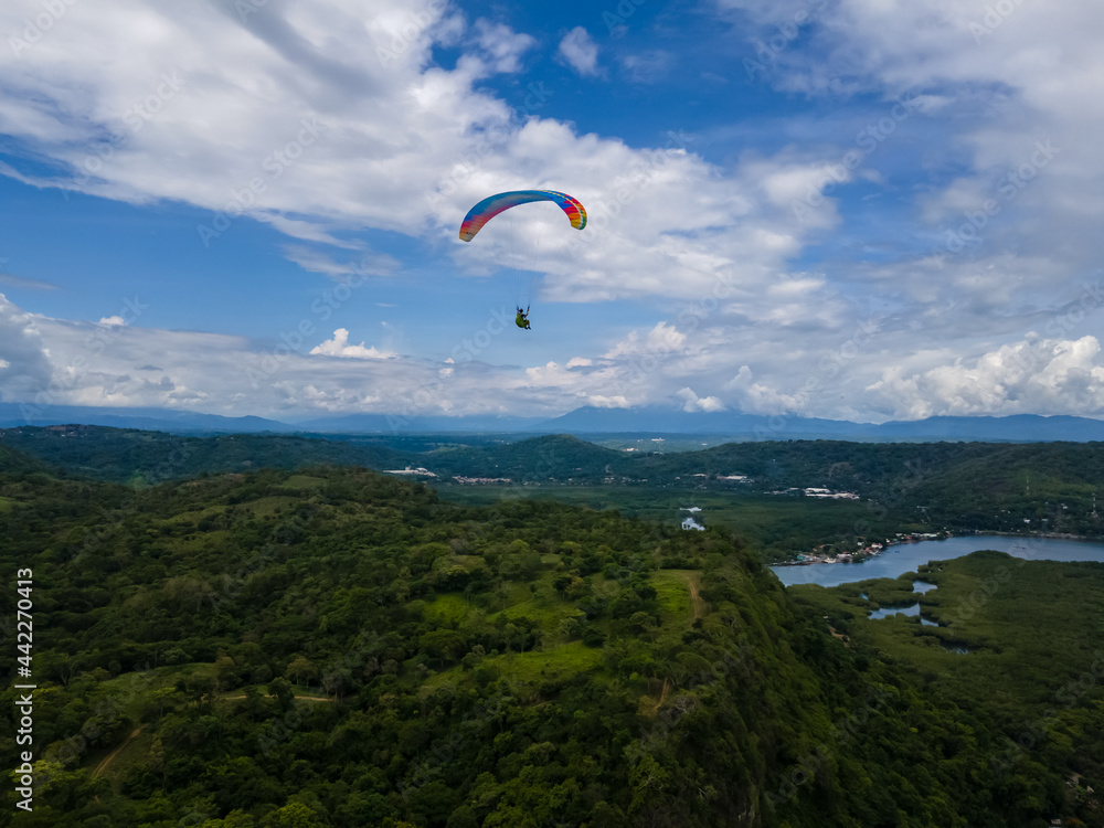 Beautiful aerial view of the extreme sport of paragliding on the Beach and mountains of Costa Rica Beautiful aerial view of the extreme sport of paragliding on the Beach and mountains of Costa Rica