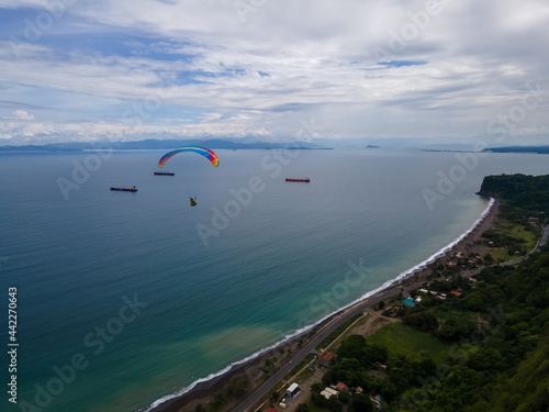 Fototapeta Naklejka Na Ścianę i Meble -  Beautiful aerial view of the extreme sport of paragliding on the Beach and mountains of Costa Rica 