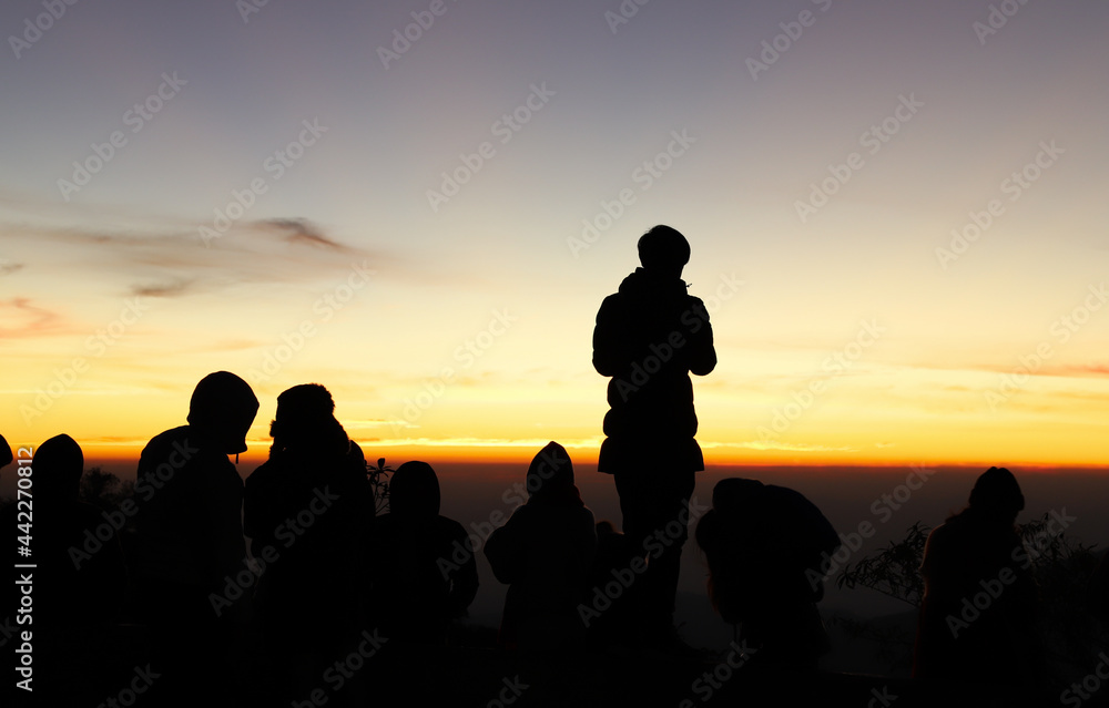 Silhouette scenery of a standing man and other people in morning dawn, . 